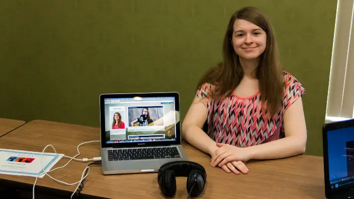 Photograph of a student showcasing their video.