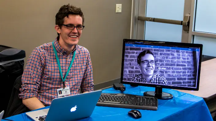 Photograph of a student showcasing their website.