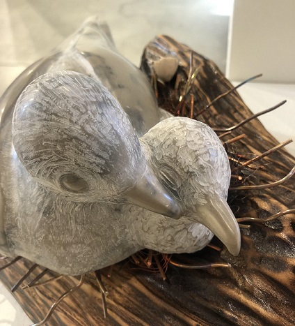 Picture of a carved dove mom and baby in stone