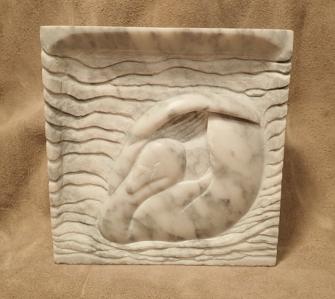 Picture of a carved relief of a swan in stone