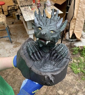 Picture of a carved dragon coming out of a tree