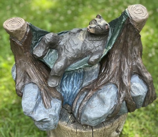 Picture of a carved bear in a hammock