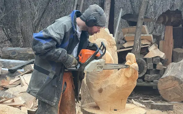 Garret carving a large chicken wood carving.